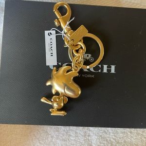 COACH X PEANUTS WOODSTOCK SNOOPY PEANUTS KEYCHAIN CHARM GOLD NWT!.